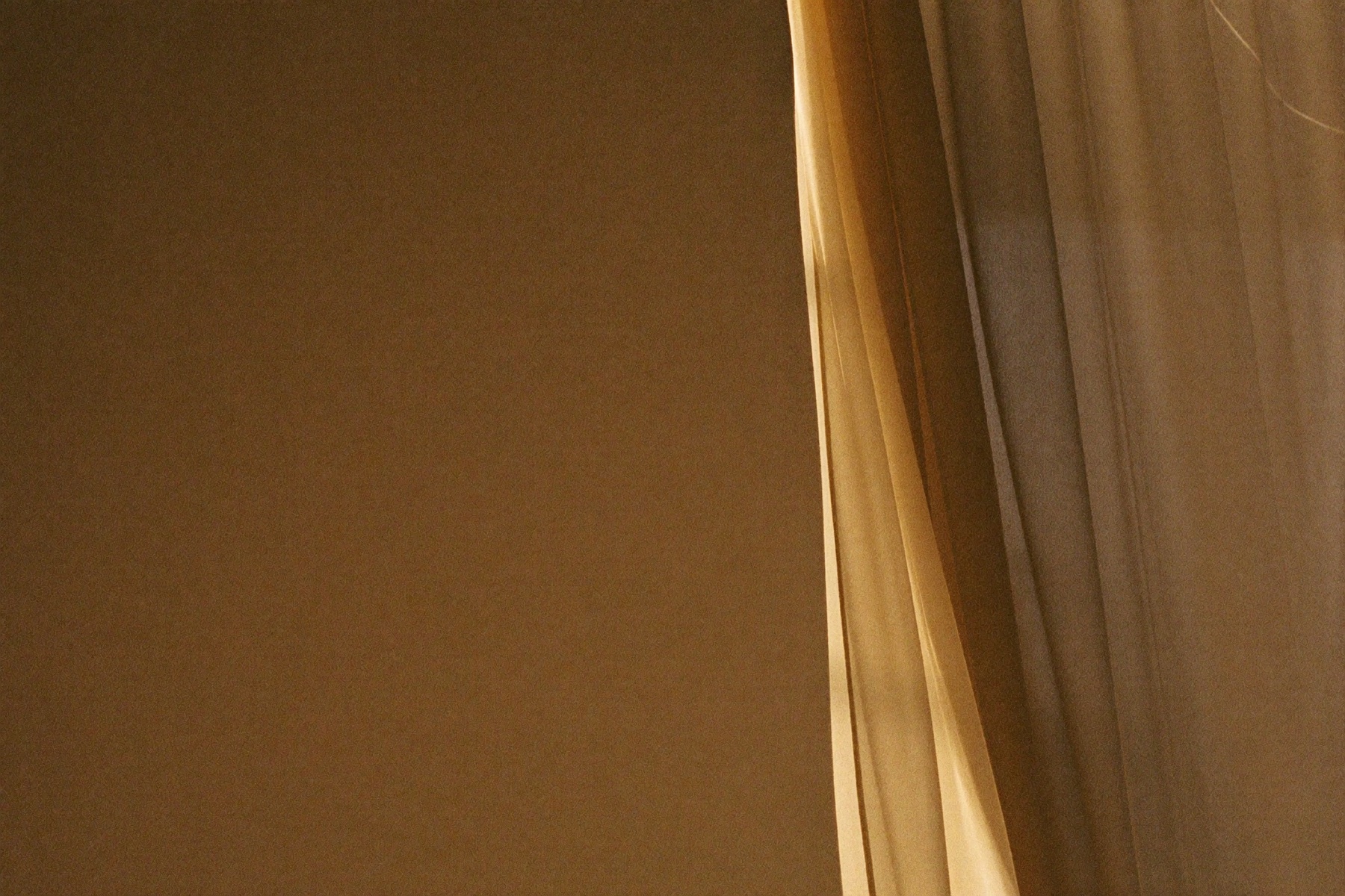 Warm golden-hour light through a sheer linen curtain