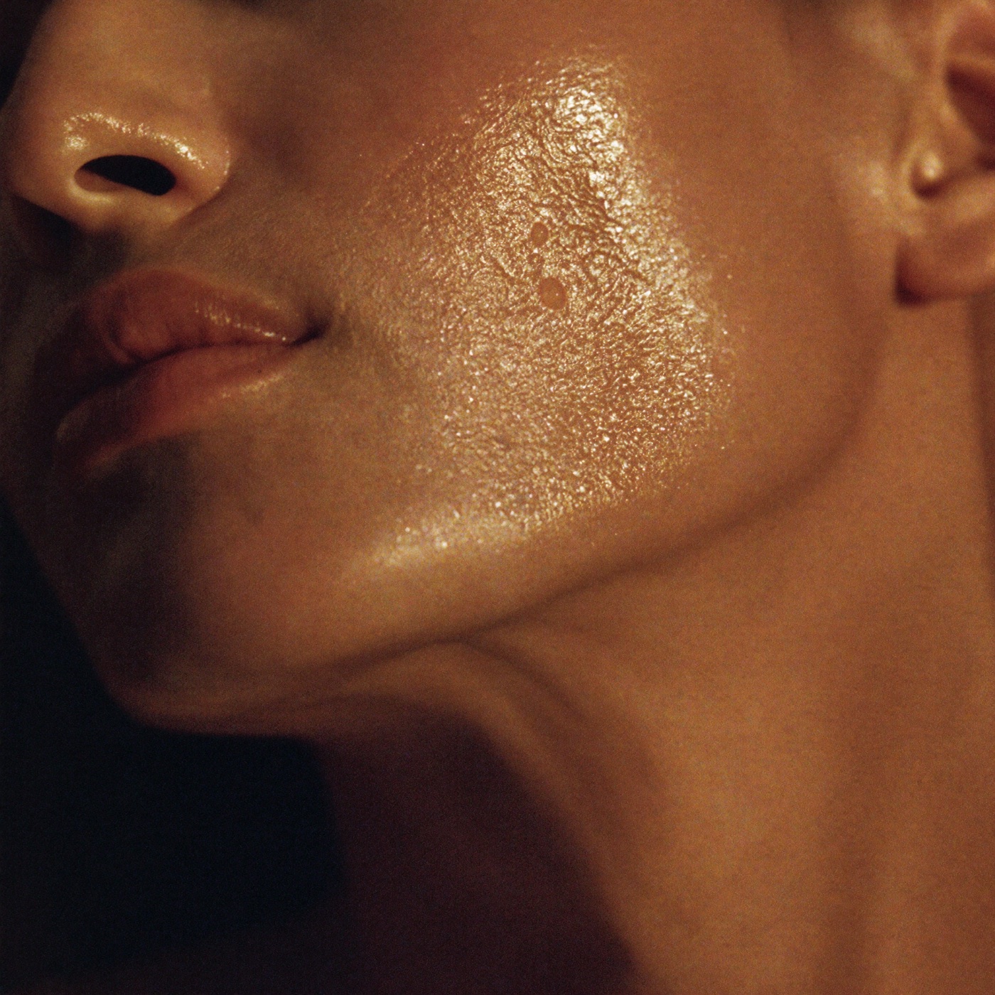 Close-up of luminous, dewy skin in warm light